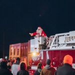 Santa waving to people from fire truck