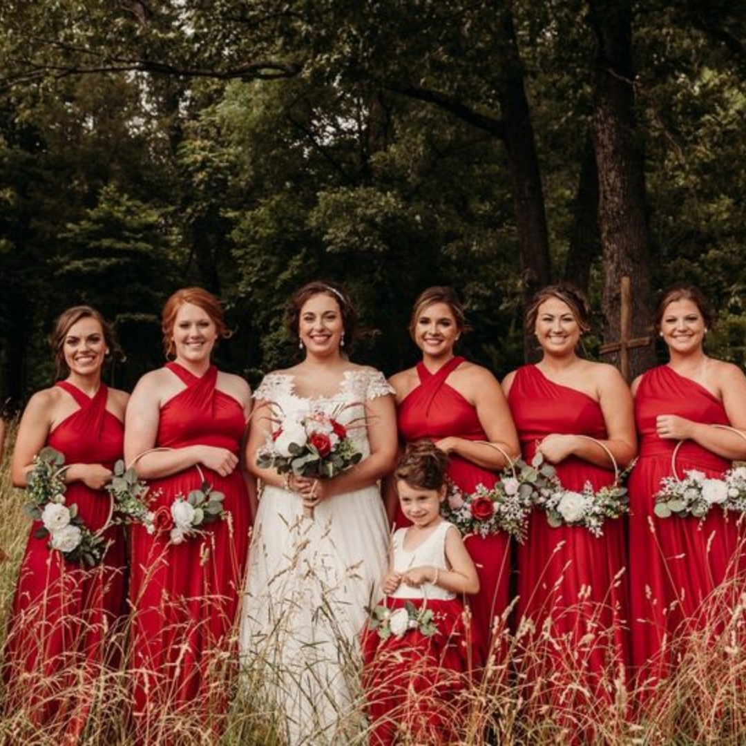 bride with her bridesmaids standing in a field at colley farm