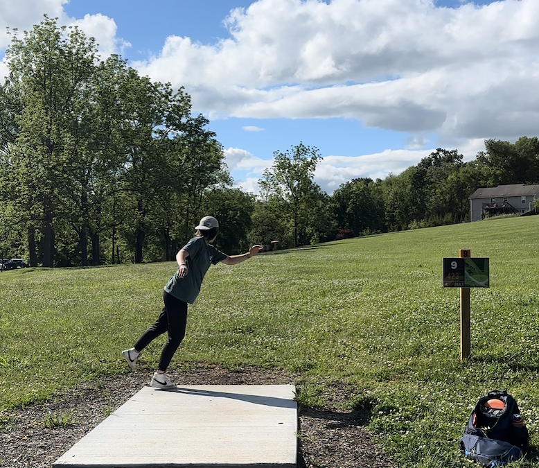 disc golfer throwing from mossy creek hole 9 tee in jefferson county tennessee