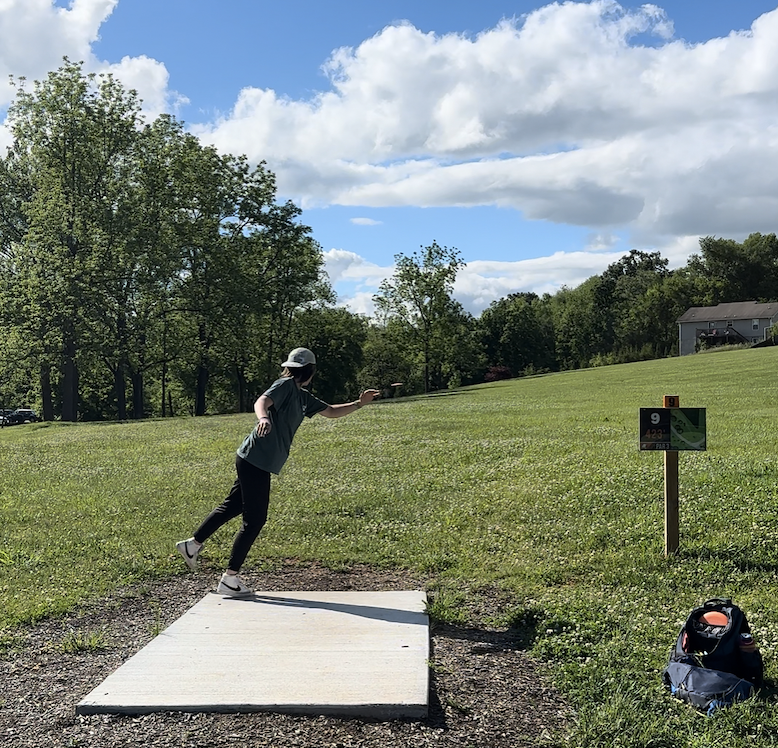 disc golfer throwing from mossy creek hole 9 tee in jefferson county tennessee