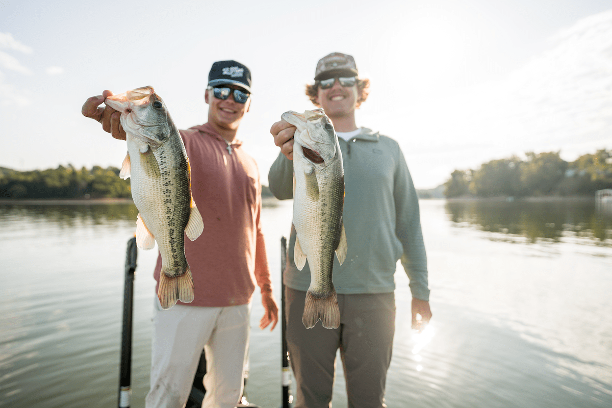 two young men holding up fish they caught in douglas lake in dandridge tennessee