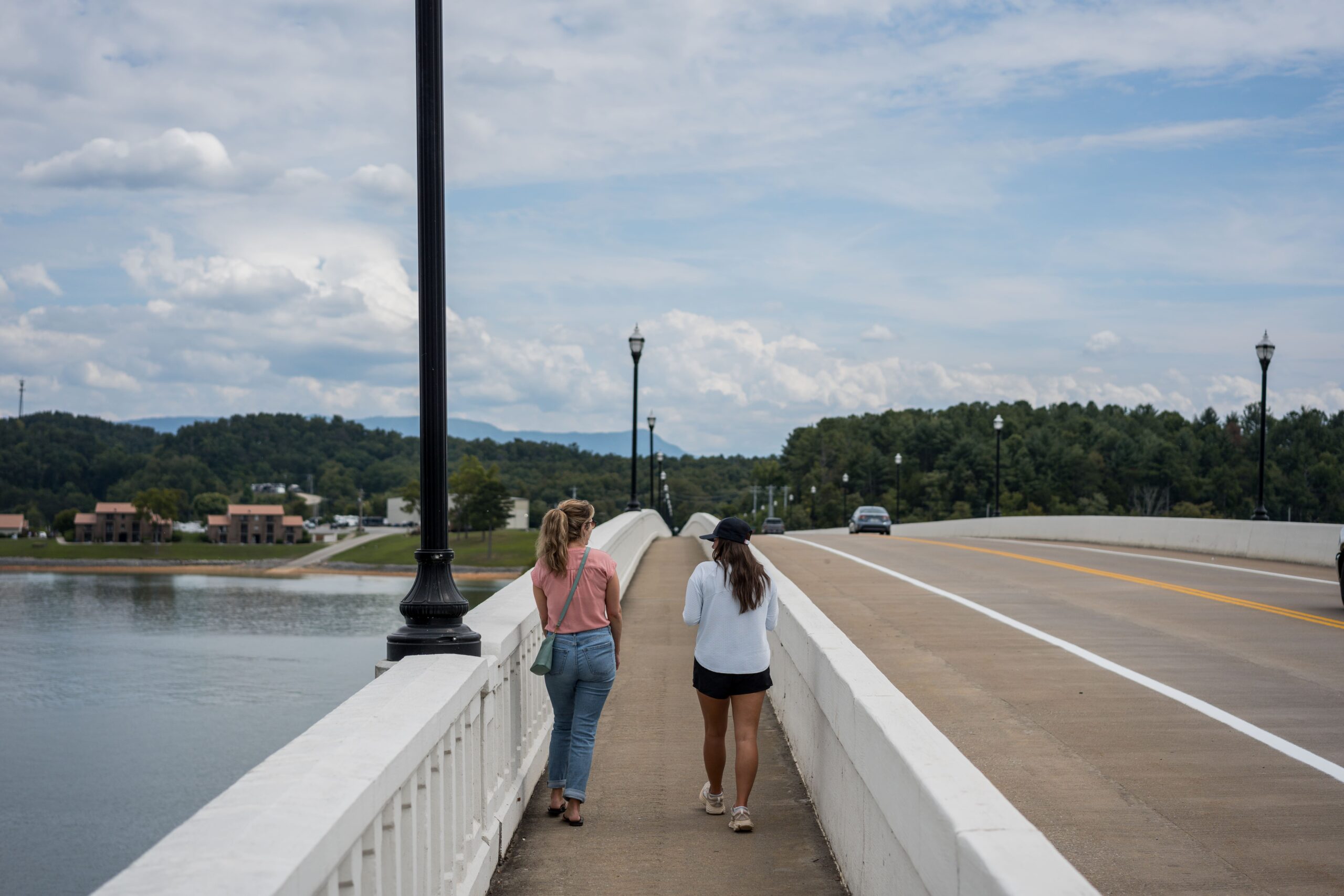 two women walking across a bridge in downtown dandridge tennessee