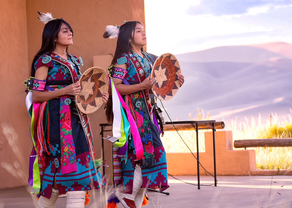 Two dancers in traditional Navajo attire.
