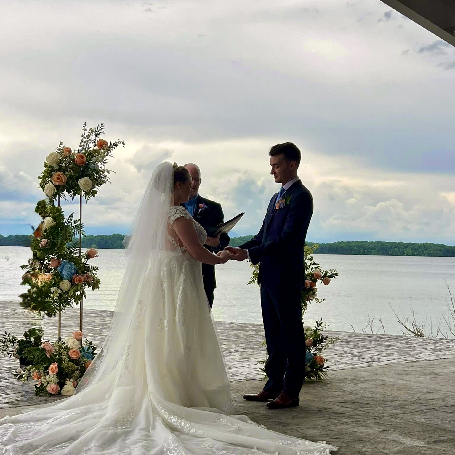 Couple exchanging vows by water